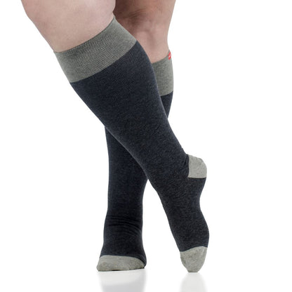 Heathered grey socks from the Heathered Collection, designed for wide calves, displayed in a close-up leg shot with a minimalist background.