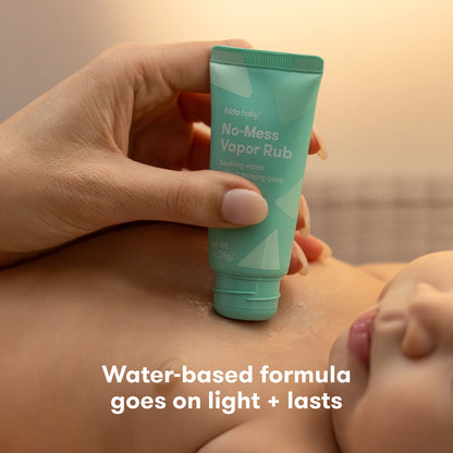Hand holding a tube of 'No-Mess Vapor Rub' over skin with text 'Water-based formula goes on light + lasts' about water-based formula.